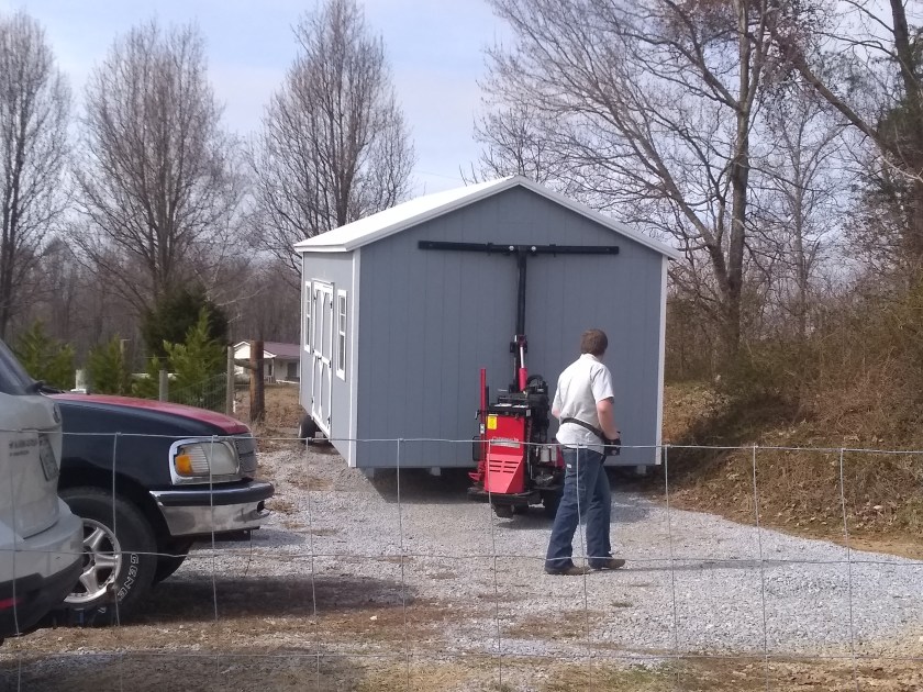 Moving the shed into position.